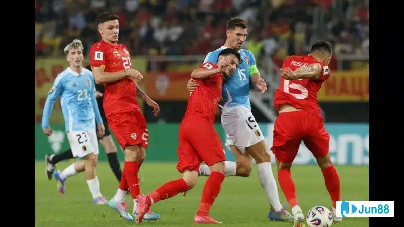 Cầu thủ Montenegro đang cố gắng ngăn chặn cầu thủ Quần đảo Faroe tiến về phía khung thành Cầu thủ Montenegro đang cố gắng ngăn chặn cầu thủ Quần đảo Faroe tiến về phía khung thành